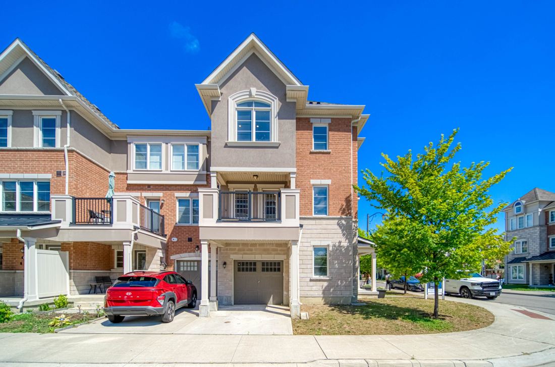 Brick end-unit townhome exterior on a sunny day